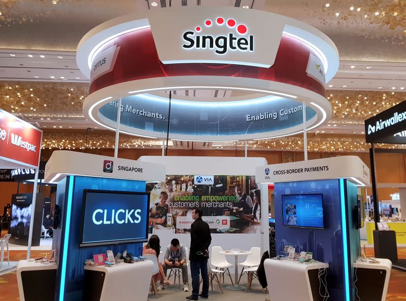 FILE PHOTO: A Singtel booth is pictured at the Money 20/20 Asia Fintech Trade Show in Singapore