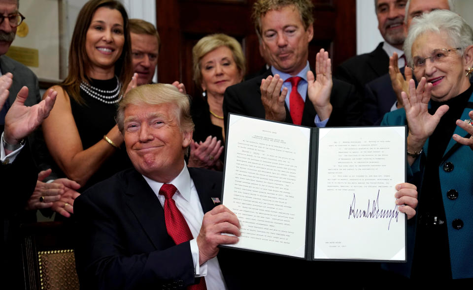 President Trump smiles after signing an Executive Order to make it easier for Americans to buy bare-bone health insurance plans and circumvent Obamacare rules, October 12, 2017.  REUTERS/Kevin Lamarque.
