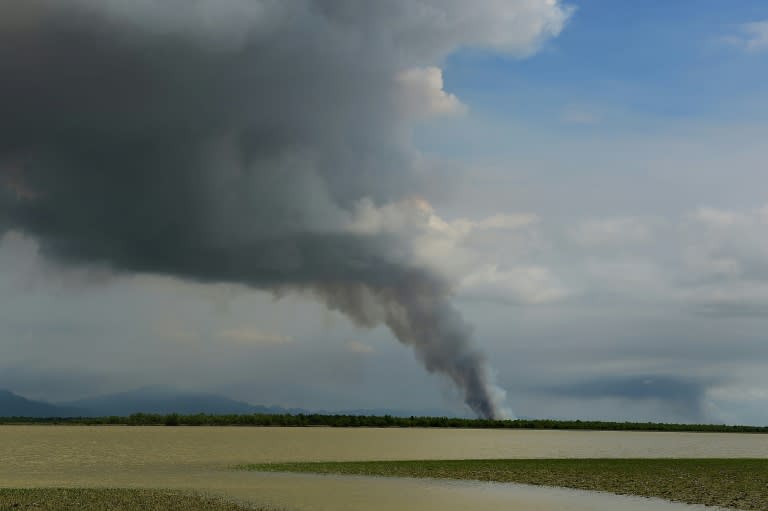 Smoke billows from a fire in an area in Myanmar's Rakhine state as seen from the Bangladeshi shore of the Naf river on September 14, 2017