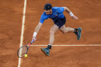 Andy Murray, of Britain, returns the ball against Dominic Thiem of Austria during their match at the Mutua Madrid Open tennis tournament in Madrid, Spain, Monday, May 2, 2022. (AP Photo/Manu Fernandez)