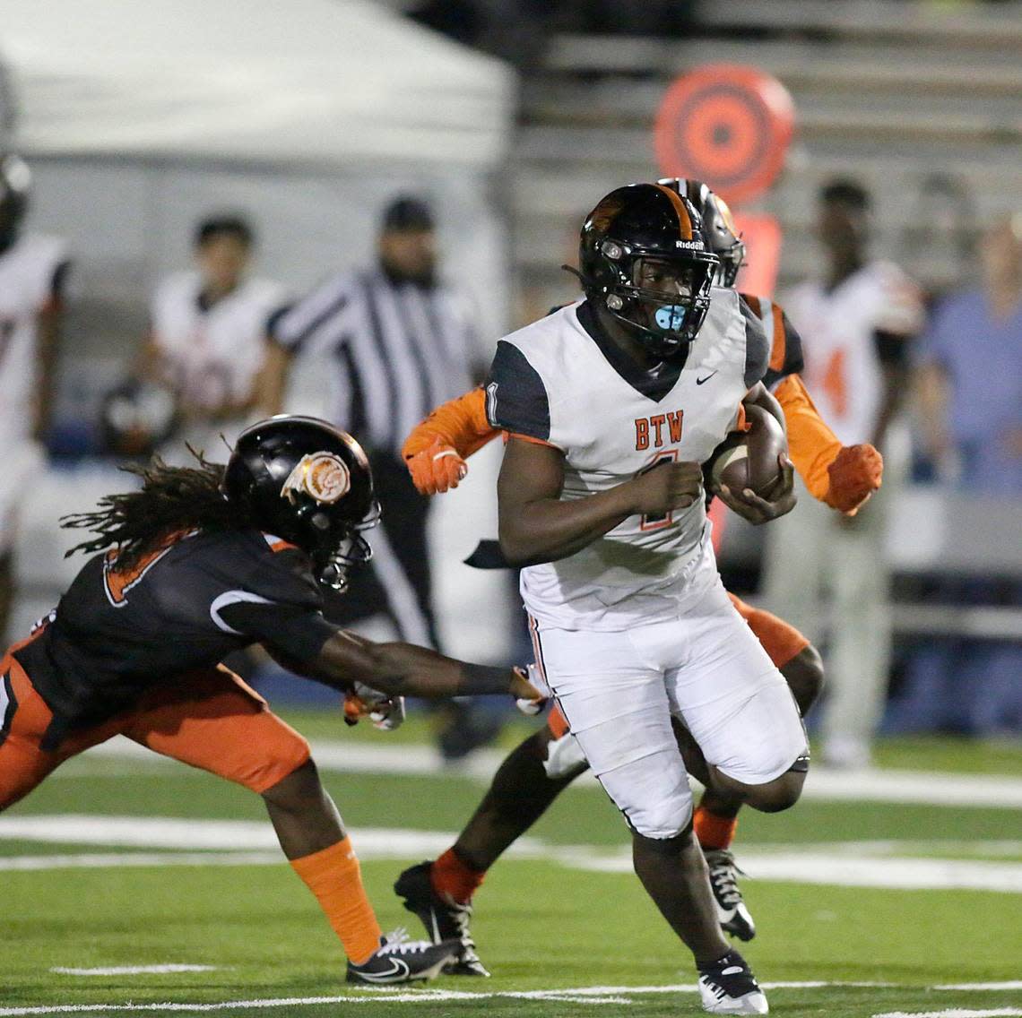 Booker T. Washington Tornadoes running back Antwan Smith (1) runs the ball against Carol City Chiefs during football game on Friday, September 23, 2022 at Traz Powell Stadium in Miami. ANDREW ULOZA/FOR THE MIAMI HERALD