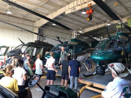 Students with the EAA Young Eagles program Sunday look over aircraft kept at the Merritt Island Airport.