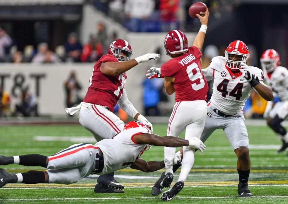 Georgia defenders can’t quite get to Alabama quarterback Bryce Young (9) during the College Football Playoff National Championship game Monday night.