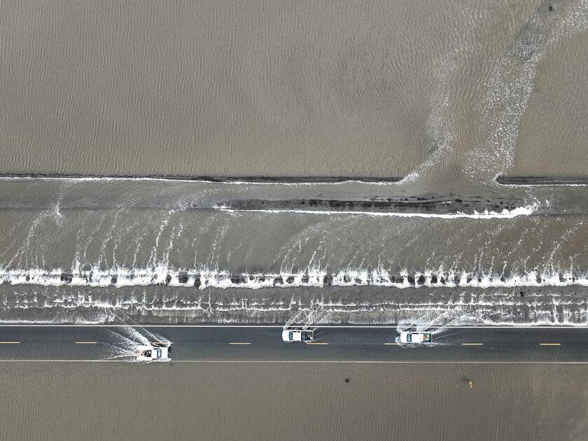 Vehicles on a flooded road.