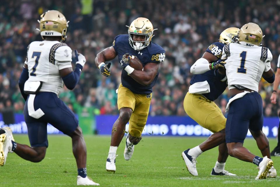 Notre Dame running back Audric Estime (7) carries the ball in the first quarter against the Navy at Aviva Stadium.