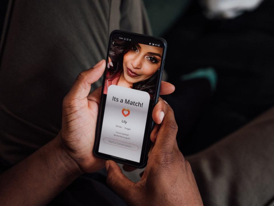 The screen shows that he’s matched with a young woman (Getty Images) (Getty Images)