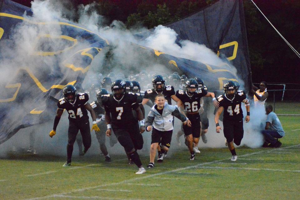 The Richmond Hill Wildcats charge onto the field for their season opener against Effingham County.