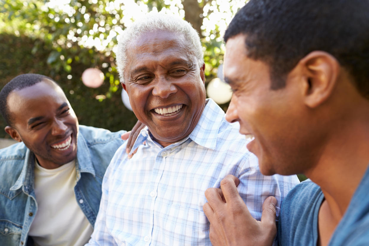 Three Black men laughing