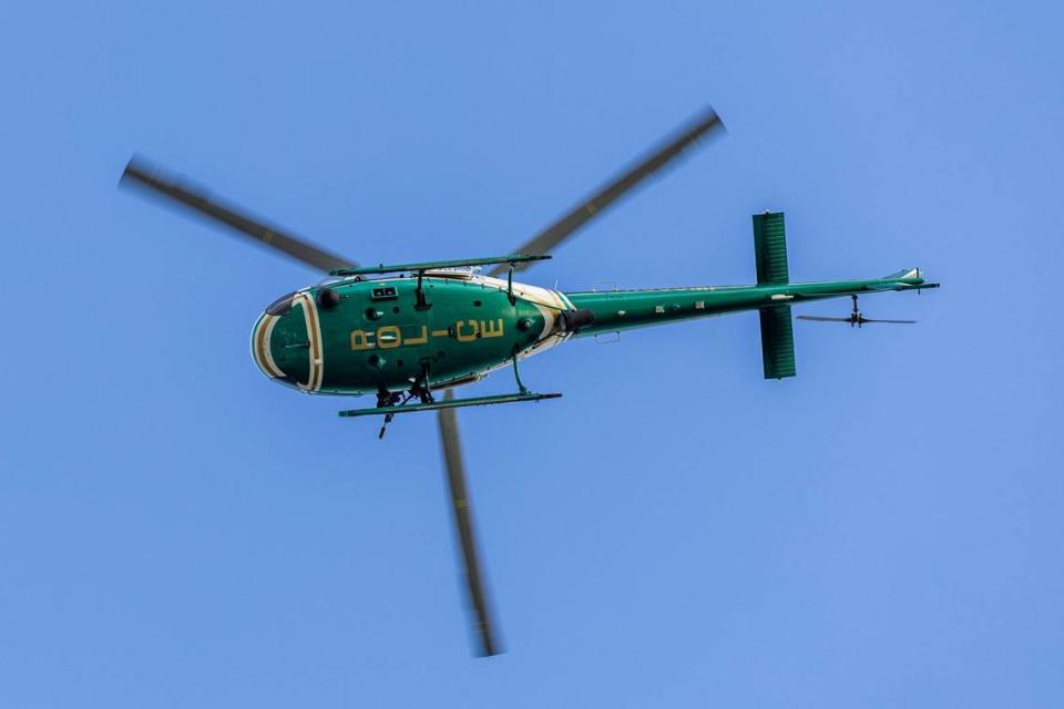 A Miami-Dade County Police helicopter soars over spectators during a South Florida Public Safety Regional Assets in Action Demonstration showcasing an active threat response incident in Biscayne Bay as part of the annual 2024 National Homeland Security Conference at PortMiami, Terminal J on Wednesday, July 24, 2024, in Miami, Fla.
