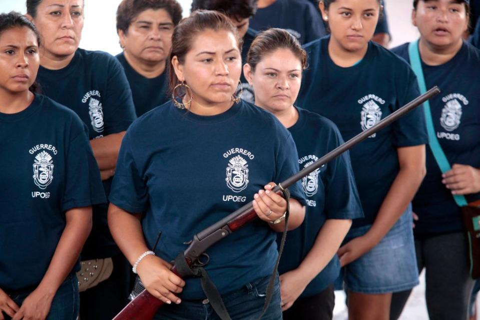 Women in Mexico during a presentation by an armed vigilante group. AFP via Getty Images