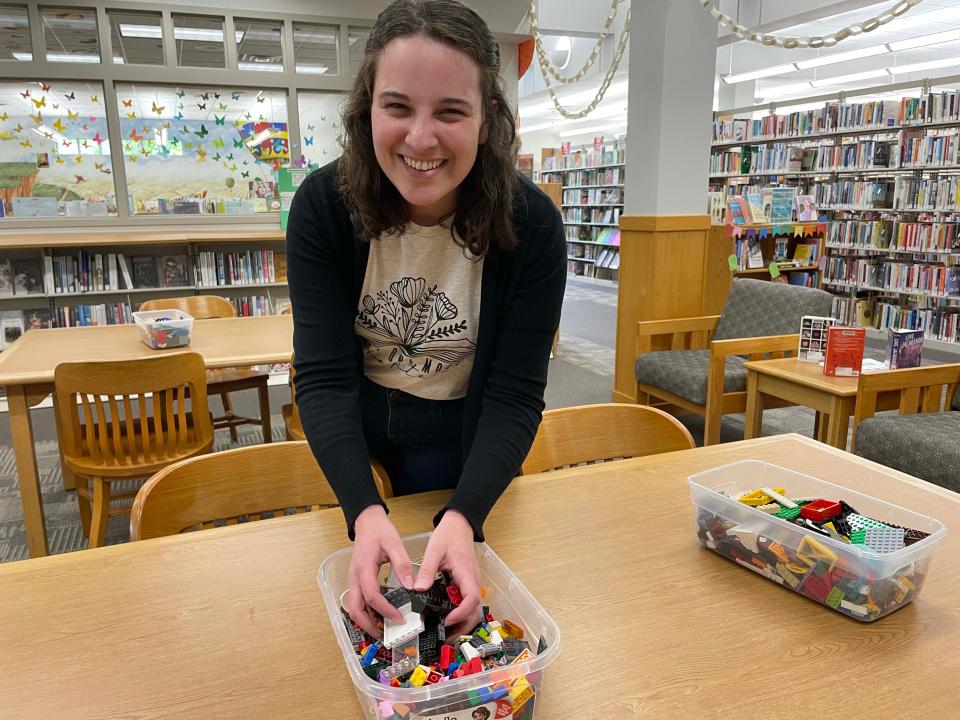 Maggie Greenisen gives a box of LEGOs the once-over before LEGO Club at Karns Branch Library. Greenisen has cause for celebration: She recently earned her master’s in Library Information Science from the University of Tennessee.