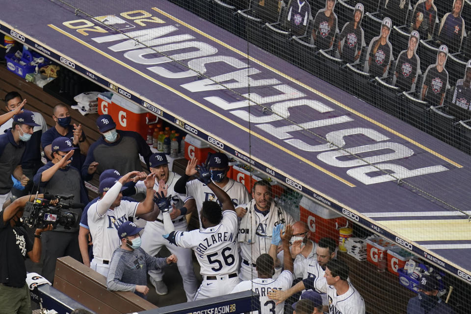 Tampa Bay Rays Randy Arozarena celebrates with his teammates after hitting a two run home run against Houston Astros pitcher Lance McCullers Jr. (43) during the first inning in Game 7 of a baseball American League Championship Series, Saturday, Oct. 17, 2020, in San Diego. (AP Photo/Gregory Bull)