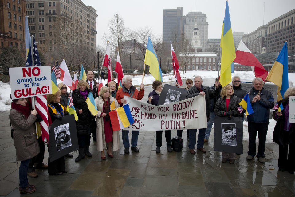 Members of the Ukrainian American and Polish American communities demonstrate in support Ukrainian anti-government protesters outside Independence Hall, Wednesday, Feb. 19, 2014, in Philadelphia. The violence on Tuesday was the worst in nearly three months of anti-government protests that have paralyzed Ukraine's capital, Kiev, in a struggle over the identity of a nation divided in loyalties between Russia and the West, and the worst in the country's post-Soviet history. (AP Photo/Matt Rourke)