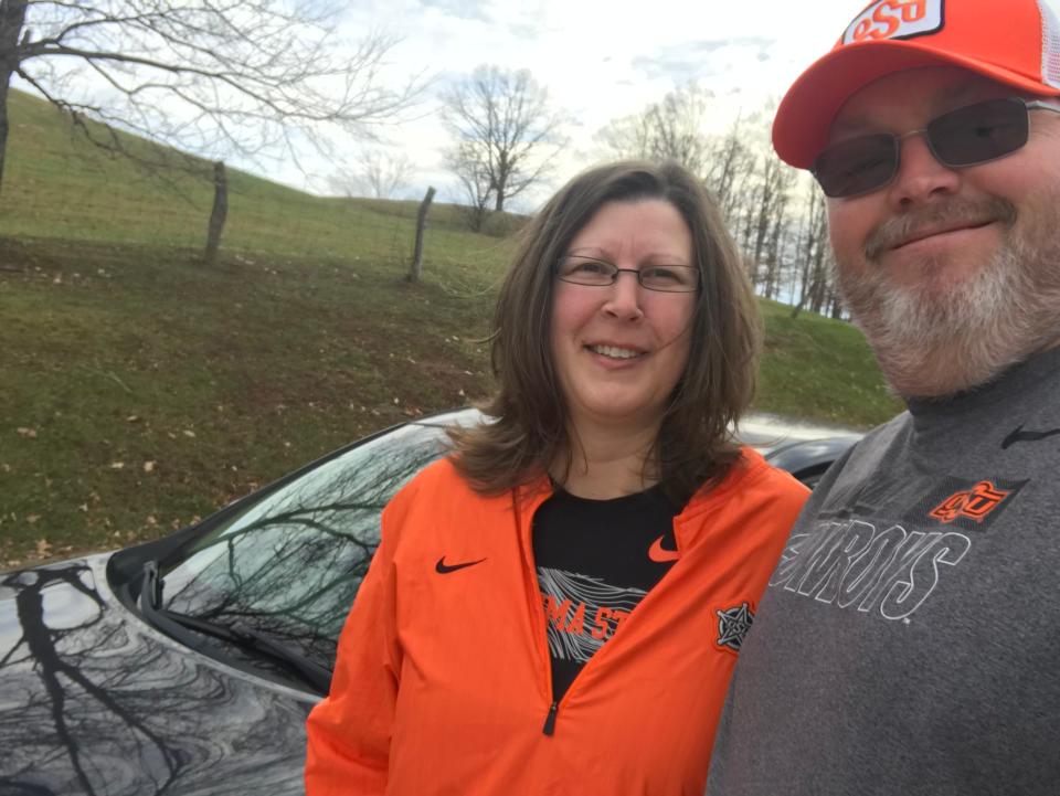 Kim and John Sills are pictured with their 2013 Nissan Altima, which recently surpassed 232,000 miles during their road trips to watch their son, Josh, play college football for Oklahoma State.