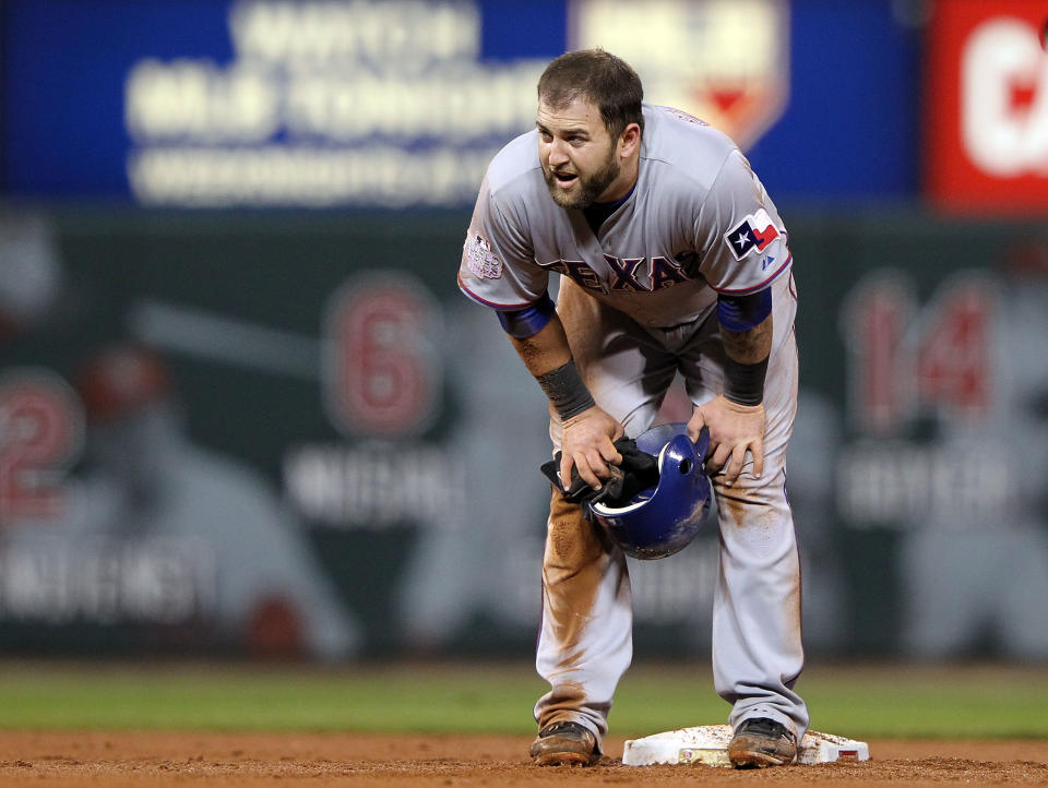 ST LOUIS, MO - OCTOBER 27: Mike Napoli #25 of the Texas Rangers stands at second base after rolling his ankle sliding after a throwing error by pitcher Fernando Salas #59 of the St. Louis Cardinals in the fourth inning during Game Six of the MLB World Series at Busch Stadium on October 27, 2011 in St Louis, Missouri. (Photo by Jamie Squire/Getty Images)