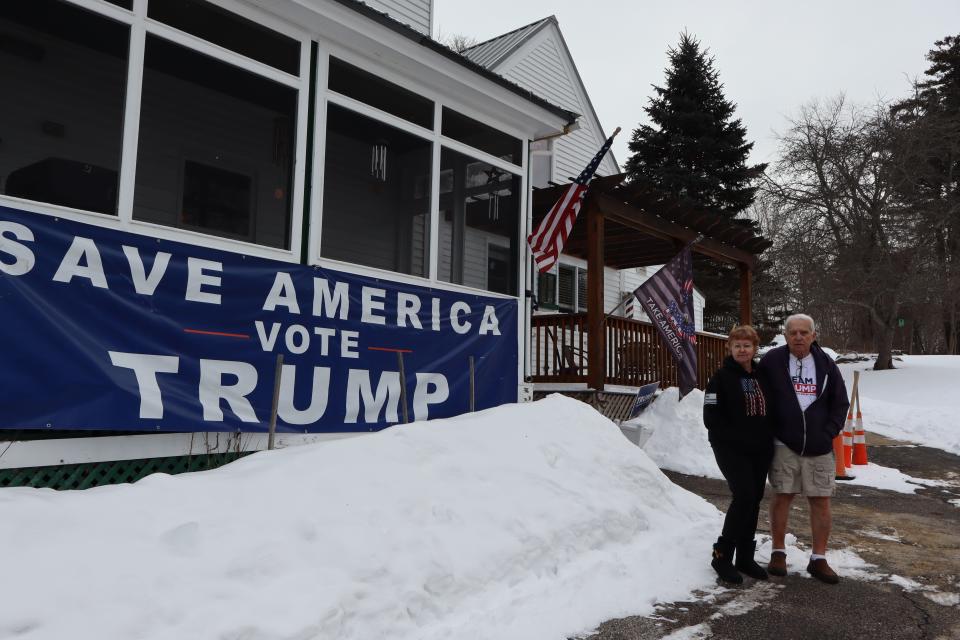 Gary and Lucy Brockney stand outside of Gary’s Barber Shop in Wolfeboro, N.H., on Jan. 20, 2024. | Samuel Benson, Deseret News