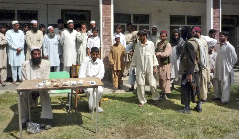 FILE - Armed supporters of an outlawed militant group 'Tehreek-e-Taliban Pakistan', right, escort one of three thieves for their trial by Taliban on the outskirts of Matta, an area of Pakistan's Swat district, Thursday, Sept. 18, 2008. The Pakistani Taliban, also known as Tehreek-e-Taliban Pakistan, or TTP, claimed responsibility for the Jan. 30, 2023 deadly suicide bombing at a mosque inside a police compound in the northwestern city of Peshawar, in one of the deadliest attacks on security forces in recent months.(AP Photo/Sherin Zada)