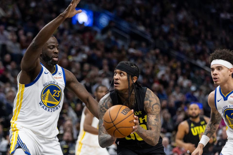 Utah Jazz guard Jordan Clarkson (00) looks to shoot the ball over Golden State Warriors forward Draymond Green (23) during a game at the Delta Center in Salt Lake City on Monday, Feb. 12, 2024. | Marielle Scott, Deseret News