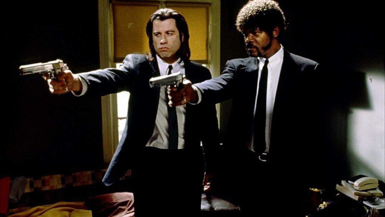  John Travolta and Samuel L. Jackson pointing guns together in Pulp Fiction. 