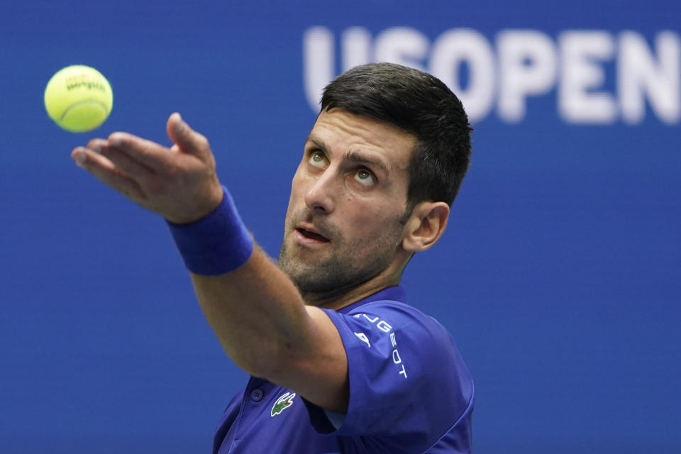 FILE - Novak Djokovic, of Serbia, serves to Daniil Medvedev, of Russia, during the men's singles final of the US Open tennis championships, Sunday, Sept. 12, 2021, in New York. Djokovic can return to the U.S. Open this year after missing the tournament in 2022, because the federal government's COVID-19 vaccination mandate for foreign air travelers will be gone as of next week. (AP Photo/John Minchillo, File)