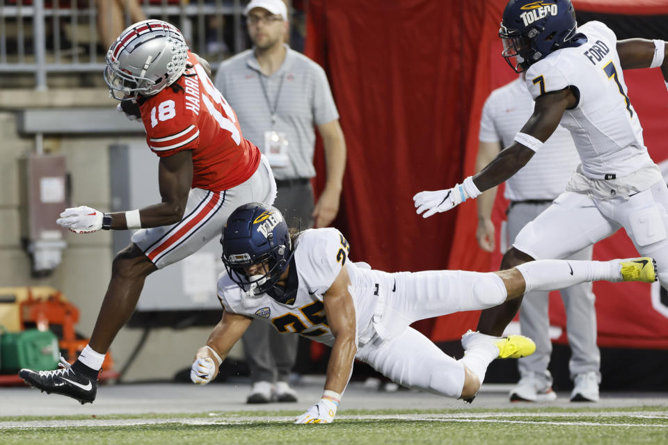 Toledo defensive back Maxen Hook, lower right, knocks Ohio State receiver Marvin Harrison out of bounds during the first half of an NCAA college football game Saturday, Sept. 17, 2022, in Columbus, Ohio. (AP Photo/Jay LaPrete)