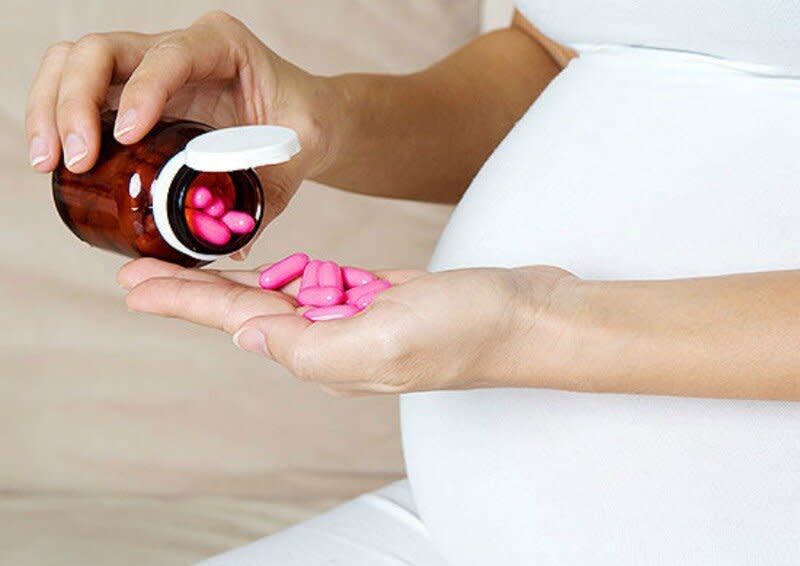 woman taking prenatal vitamins side effects