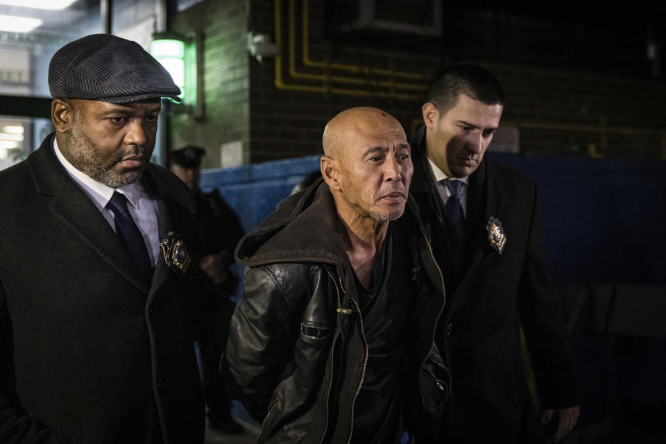 Weng Sor is walked by New York Police Department detectives out of the 68th Precinct in the Brooklyn borough of New York, Tuesday, Feb. 14, 2023. Sor was charged Tuesday with murder and attempted murder after he went on a deadly rampage with a U-Haul truck a day earlier in New York City. (AP Photo/Stefan Jeremiah)