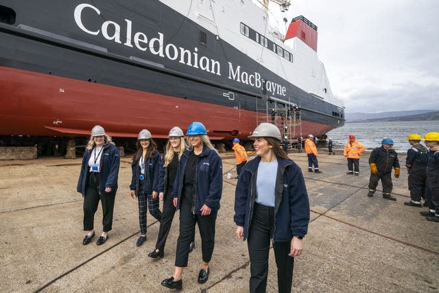 Ferguson Marine workers walking alongside the ship ahead of it's launch