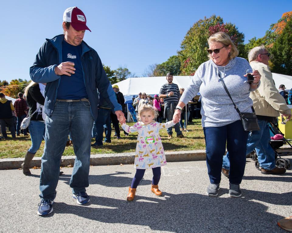 Three-year-old Stella Brown dances with her grandparents Jim and Lisa Brown, at the 2019 Exeter Powder Keg Beer & Chili Festival on Swasey Parkway.