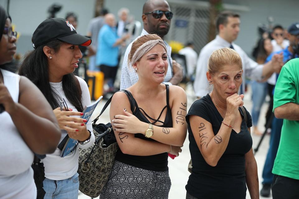 <p>People react after watching the hearse carrying Miami Marlins pitcher Jose Fernandez pass in front of the Marlins baseball stadium on September 28, 2016 in Miami, Florida. Mr. Fernandez was killed in a weekend boat crash in Miami Beach along with two friends. (Photo by Joe Raedle/Getty Images) </p>