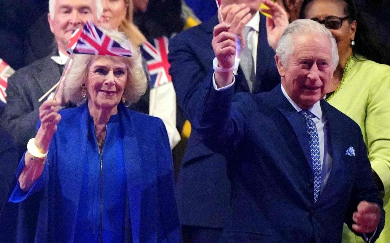 Queen Camilla and King Charles III wave at the Coronation Concert - AFP