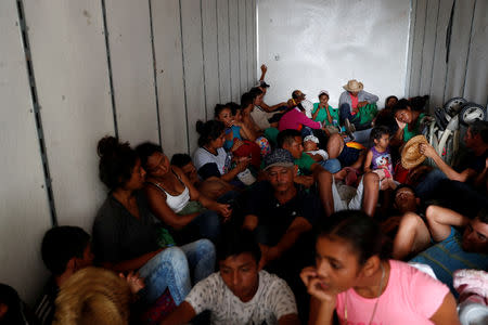 Eight months pregnant Honduran migrant Erly Marcial, 21, sits with her family and others in the back of a truck, as they hitch a ride towards the U.S., near Sayula de Aleman, Mexico, November 11, 2018. REUTERS/Carlos Garcia Rawlins