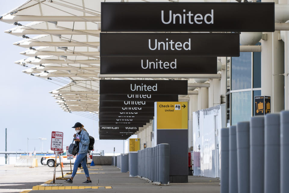 DENVER, CO - APRIL 22: A woman walks to her car at an empty passenger drop off area at Denver International Airport as the coronavirus pandemic slows air travel on April 22, 2020 in Denver, Colorado. Compared to the same time last year, Denver International Airport is operating 1,000 fewer flights daily. (Photo by Michael Ciaglo/Getty Images)