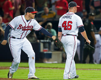 Braves first baseman Freddie Freeman taps reliever Craig Kimbrel as the closer leaves the mound in the ninth inning