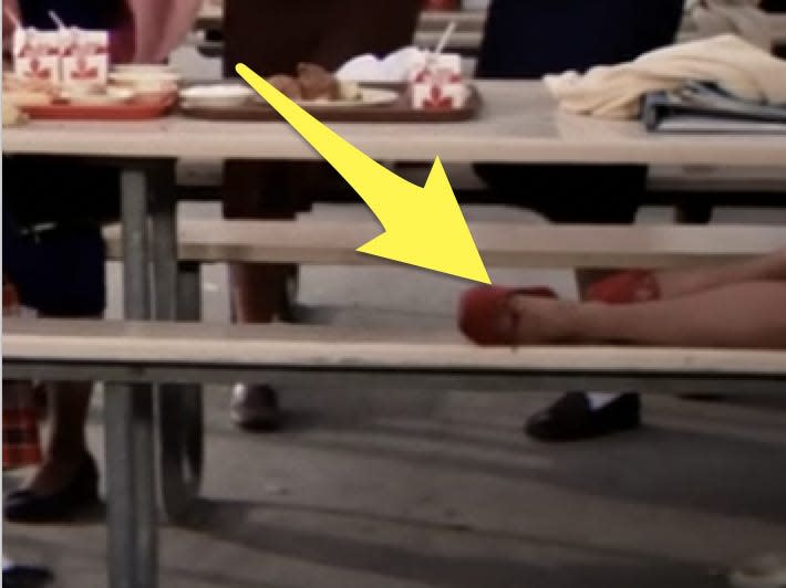 rizzo's red high-heel shoe on a cafeteria bench grease