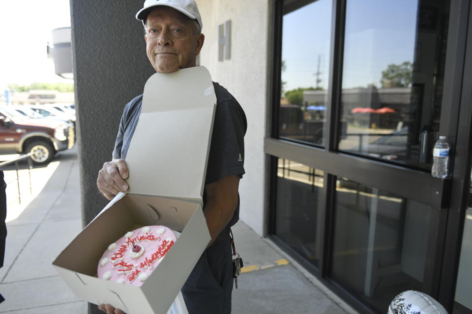 George Hefner, of Roxborough Village, became emotional after buying a cake with the inscription "God Bless America and Masterpiece Cakeshop," from baker Jack Phillips, owner of Masterpiece Cakeshop. "He fought hard for us and our religious freedom," Hefner said. (Photo: Joe Amon via Getty Images)