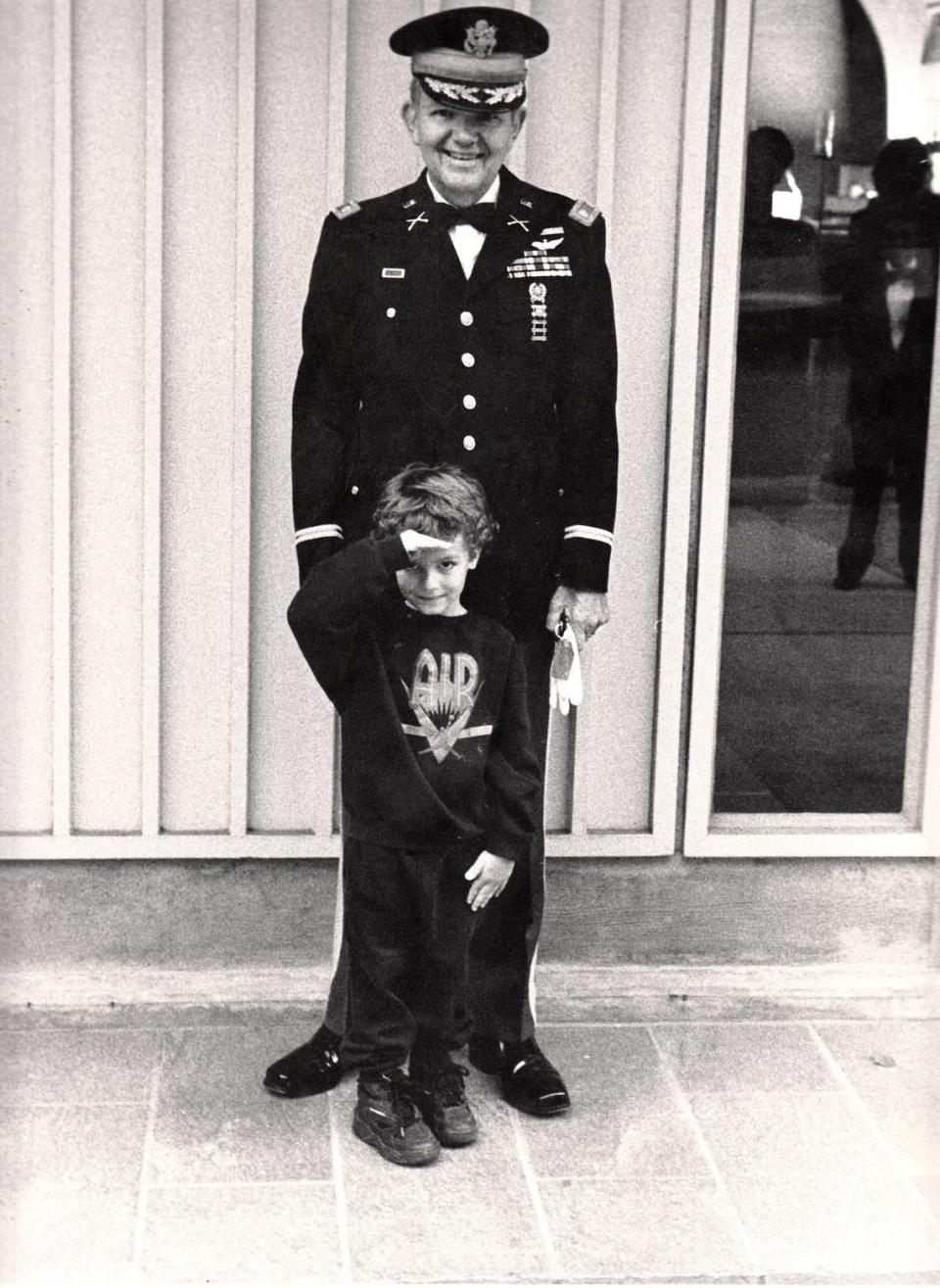 Jim Goetcheus stands in uniform with his grandchild, Ryan Sarfan, in 1994, at his daughter’s wedding. Goetcheus served as a career military officer for more than 20 years, including two tours in Vietnam where he earned a Purple Heart and a Bronze Star. He wanted to have a funeral at Arlington National Cemetery.