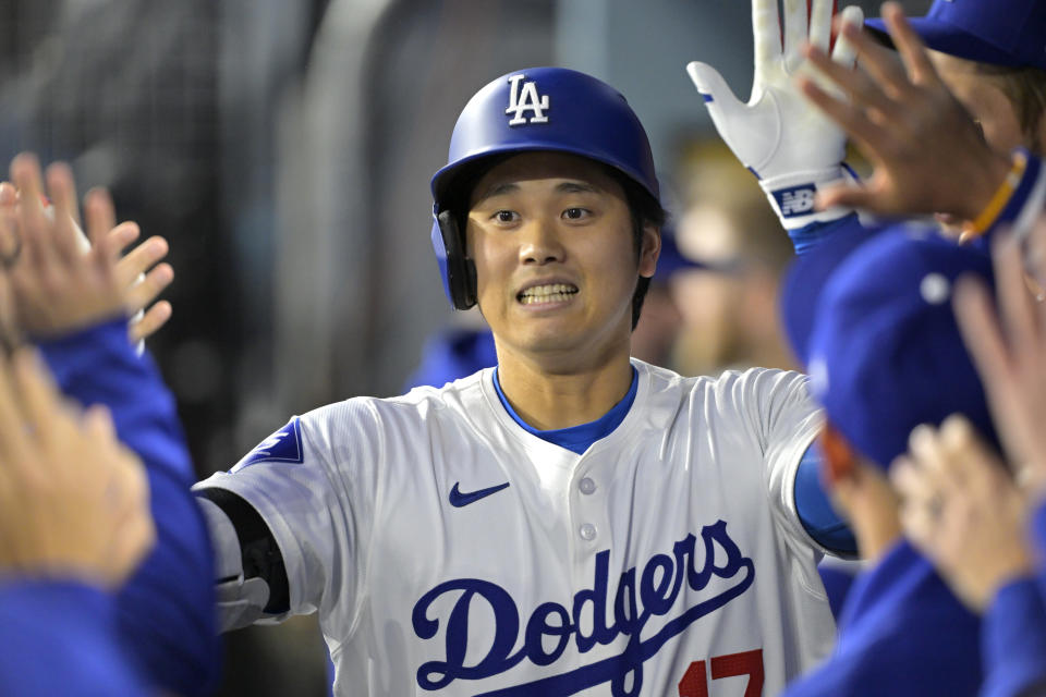LOS ANGELES, CALIFORNIA - APRIL 12: Shohei Ohtani #17 of the Los Angeles Dodgers is congratulated in the dugout after hitting a solo home run in the first inning against the San Diego Padres at Dodger Stadium on April 12, 2024 in Los Angeles, California. (Photo by Jayne Kamin-Oncea/Getty Images)