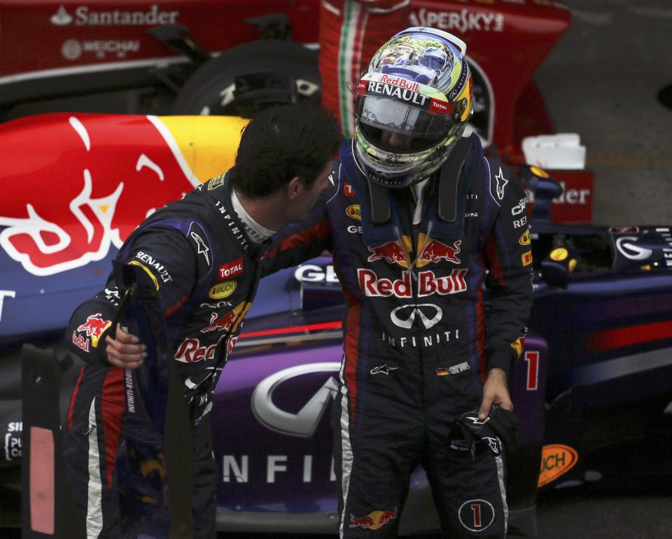 Sebastian Vettel of Germany greets Mark Webber of Australia after the Brazilian F1 Grand Prix at the Interlagos circuit in Sao Paulo