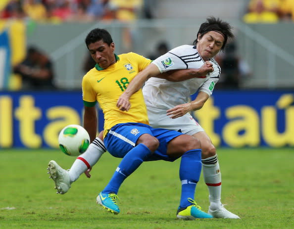 BRASILIA, BRAZIL - JUNE 15: Paulinho of Brazil battles for the ball with Yasuhito Endo of Japan during the FIFA Confederations Cup Brazil 2013 Group A match between Brazil and Japan at National Stadium on June 15, 2013 in Brasilia, Brazil. (Photo by Scott Heavey/Getty Images)