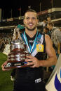 Travis Boak of the Power holds the Showdown trophy after Port defeated the Crows in the SA derby.