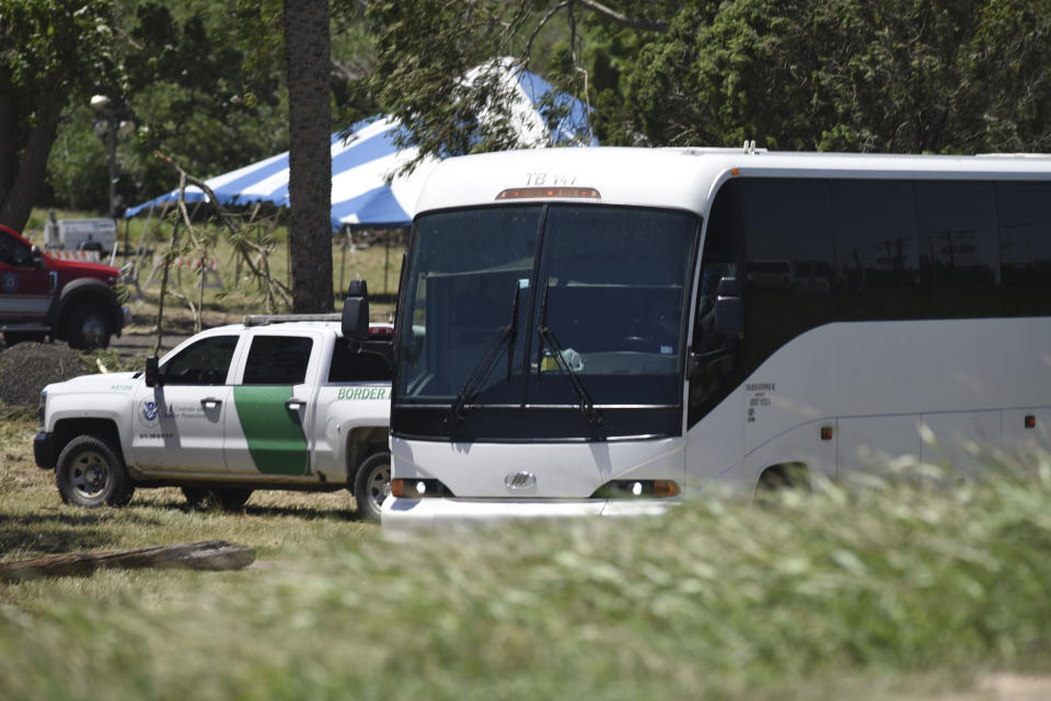 A Border Patrol vehicle and bus are parked near a staging area near the U.S.-Mexico border in Brownsville, Texas, Saturday, April 29, 2023. The city of Brownsville signed a disaster declaration after nearly 15,000 migrants crossed through the area, with many of them screened and released from federal custody into the city. (AP Photo/Valerie Gonzalez)