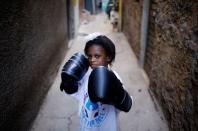 Marcia, poses for a photograph in an alley, also known as "viela", in the Mare favela of Rio de Janeiro, Brazil, June 2, 2016. REUTERS/Nacho Doce