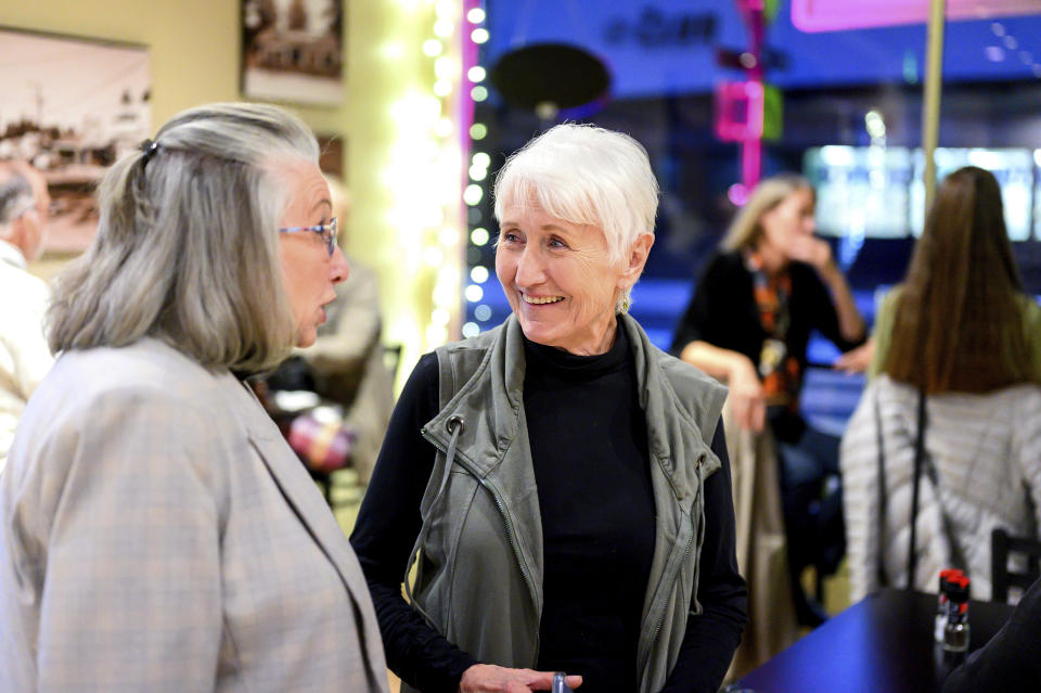 Nic's Deli & Wine Bar owner Nikki Jones, right, speaks with Kathy Dysert, Wednesday, Oct. 25, 2023, in Paradise, Calif. Jones lost two businesses in 2018's Camp Fire. (AP Photo/Noah Berger)