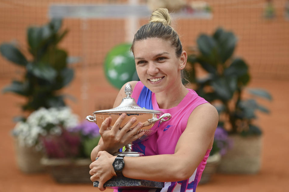 Romania's Simona Halep poses with her trophy after beating Czech Republic's Karolina Pliskova during their final match at the Italian Open tennis tournament, in Rome, Monday, Sept. 21, 2020. (Alfredo Falcone/LaPresse via AP)