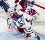 Toronto Maple Leafs centre Auston Matthews (34) falls over Montreal Canadiens goaltender Carey Price (31) during the third period of Game 6 of an NHL hockey Stanley Cup first-round playoff seres Saturday, May 29, 2021, in Montreal. (Ryan Remiorz/The Canadian Press via AP)