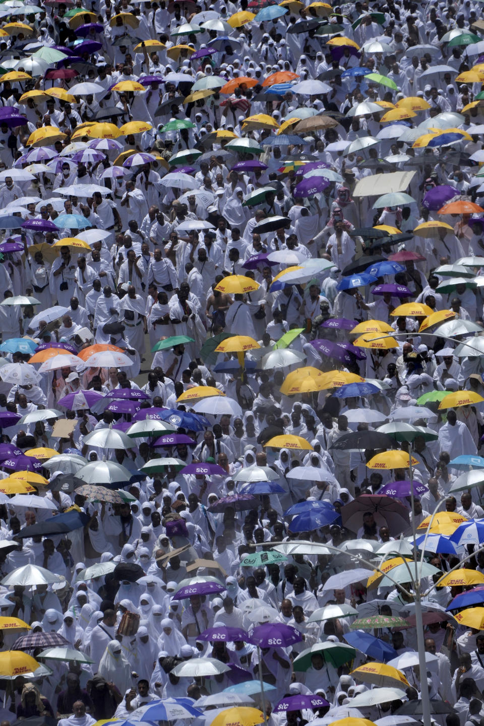 Muslim pilgrims move on their way to perform Friday Prayers at Namira Mosque in Arafat, on the second day of the annual hajj pilgrimage, near the holy city of Mecca, Saudi Arabia, Friday, July 8, 2022. (AP Photo/Amr Nabil)