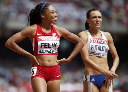 Allyson Felix of U.S. (L) celebrates winning the women's 400 metres heats during the 15th IAAF World Championships at the National Stadium in Beijing, China August 24, 2015. REUTERS/Lucy Nicholson