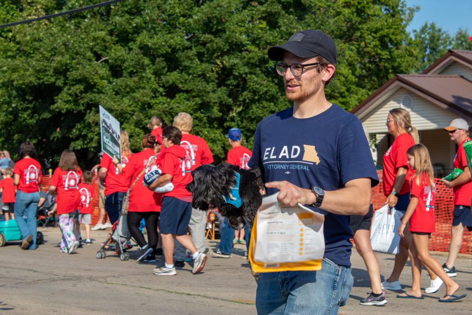 Elad Gross, a Democratic candidate for Missouri Attorney General in 2024, and his dog Liberty Belle participate in the Labor Day Parade.