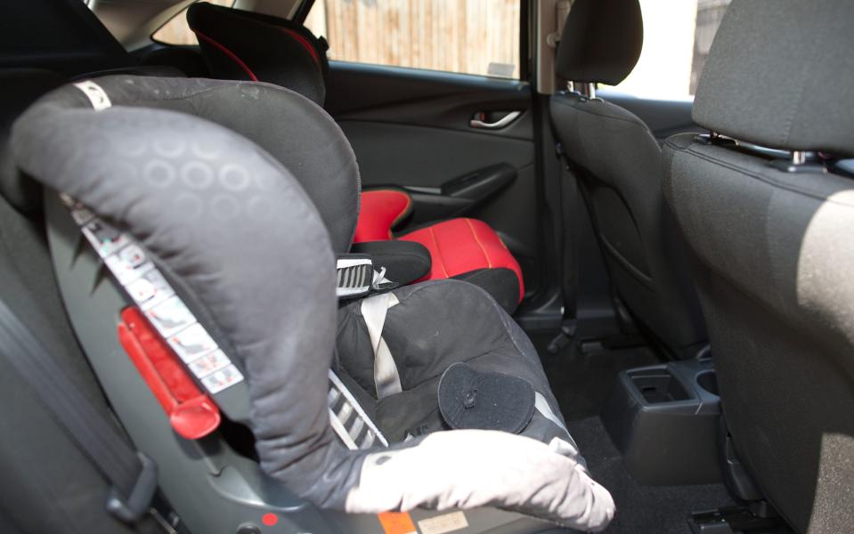 child seat positioned in back seat of a car - Jeff Gilbert